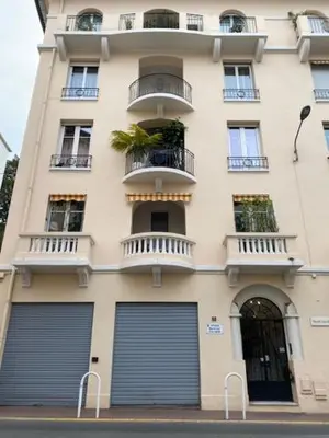 a tall building with two garage doors in front of it at Trois pièces Gallieni in Cannes