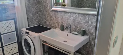 a bathroom with a sink and a washing machine at Magnifique deux pièces Lacour in Cannes