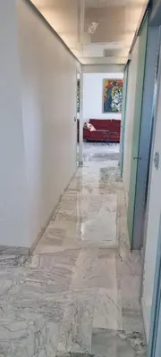 a hallway with a marble floor in a building at Magnifique deux pièces Lacour in Cannes