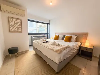 a white bed in a bedroom with a window at Charming Terrace Apartment with Garden Views - Cannes City Center in Cannes