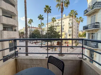 a small table and chairs on a balcony with a view at Charming Terrace Apartment with Garden Views - Cannes City Center in Cannes