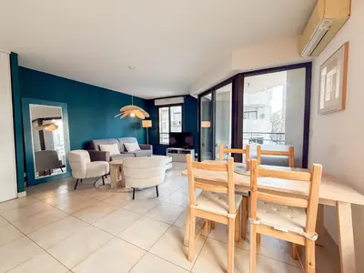 a living room with a couch and a table at Charming Terrace Apartment with Garden Views - Cannes City Center in Cannes