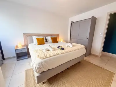 a kitchen with white cabinets and a sink and a refrigerator at Charming Terrace Apartment with Garden Views - Cannes City Center in Cannes