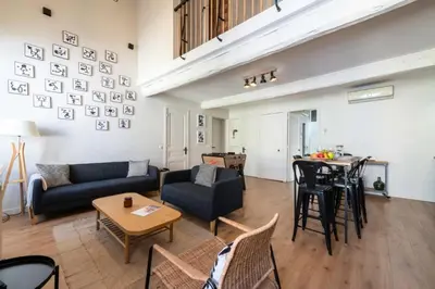 a living room with a couch and a table at Résidence Rare ! Duplex De Style En Plein Centre Ville - RARE ! Duplex de style en plein centre ville MAE-5823 in Cannes