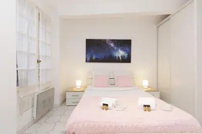 a bedroom with two beds and a painting on the wall at Volupte YourHostHelper in Cannes