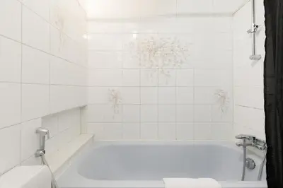 a white bathroom with a tub and a toilet at Volupte YourHostHelper in Cannes
