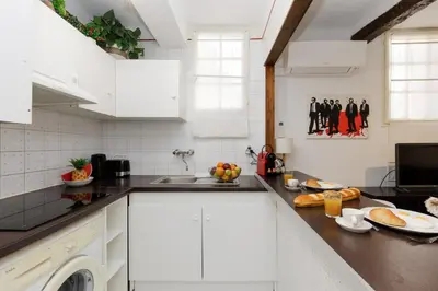 a white kitchen with a sink and a dishwasher at Volupte YourHostHelper in Cannes