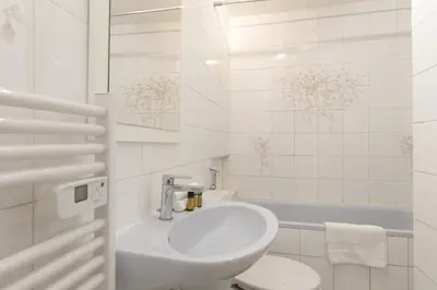 a bathroom with a sink and a toilet and a tub at Volupte YourHostHelper in Cannes