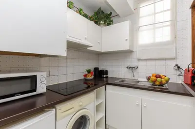 a white kitchen with a sink and a microwave at Volupte YourHostHelper in Cannes
