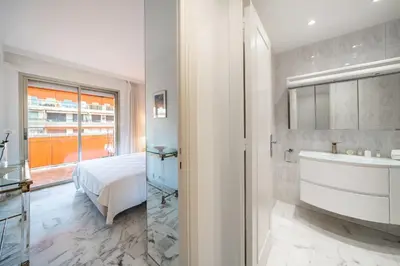 a bathroom with a bed and a sink and a tub at 2 pièces à deux pas du centre ville de Cannes in Cannes