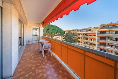 a balcony with a table and some buildings at 2 pièces à deux pas du centre ville de Cannes in Cannes