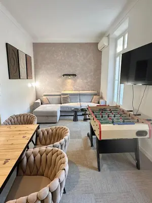 a living room with a pool table and a couch at 2 bedrooms, large terrace, city center in Cannes