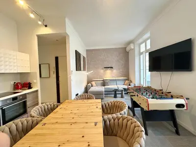a living room with a ping pong table in a room at 2 bedrooms, large terrace, city center in Cannes