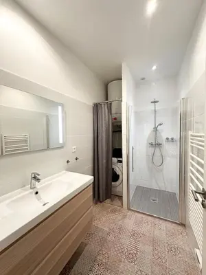 a white bathroom with a sink and a shower at 2 bedrooms, large terrace, city center in Cannes