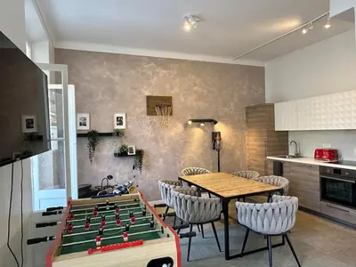 a dining room with a table and a pool table at 2 bedrooms, large terrace, city center in Cannes