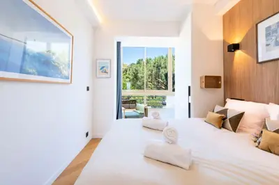 a bedroom with a large white bed with two towels on it at Résidence 3p Terrasse Vue Mer – Résidence De Standing - 3P Terrasse Vue Mer – Résidence de Standing MAE-3293 in Cannes