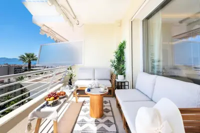 a living room with a couch and a tv on a balcony at Résidence 3p Terrasse Vue Mer – Résidence De Standing - 3P Terrasse Vue Mer – Résidence de Standing MAE-3293 in Cannes