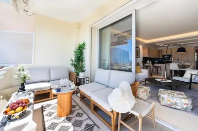 a living room with a couch and a table at Résidence 3p Terrasse Vue Mer – Résidence De Standing - 3P Terrasse Vue Mer – Résidence de Standing MAE-3293 in Cannes