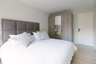 a bedroom with a large white bed with white pillows at Blue Dream in Le Cannet