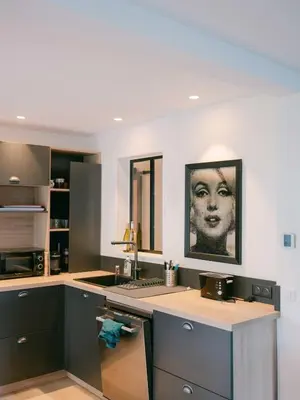 a kitchen with a counter with a picture of a woman at Blue Dream in Le Cannet