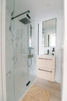 a bathroom with a glass shower and a sink at Blue Dream in Le Cannet