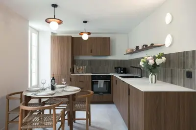 a kitchen with a table and some chairs and a counter at Maya Cannes in Cannes