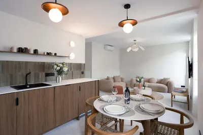 a kitchen and living room with a table and chairs at Maya Cannes in Cannes