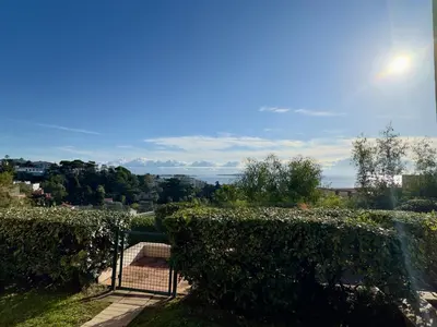 a view from a garden with a fence and bushes at Les Ingres 2 - SCLS Rentals in Cannes