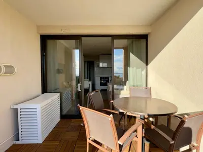a dining room with a table and chairs at Les Ingres 2 - SCLS Rentals in Cannes