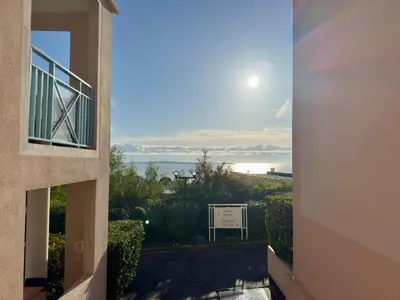 a view of the ocean from a balcony of a building at Les Ingres 2 - SCLS Rentals in Cannes