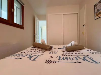 a bedroom with a bed with two pillows on it at Les Ingres 2 - SCLS Rentals in Cannes