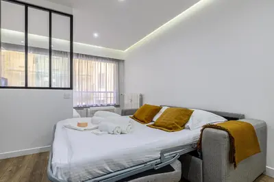 a bedroom with a bed with towels on it at 8 MERLE T2 - Appartement moderner pour 4 personnes proche Palais in Cannes