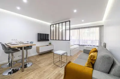 a living room with a couch and a table at 8 MERLE T2 - Appartement moderner pour 4 personnes proche Palais in Cannes