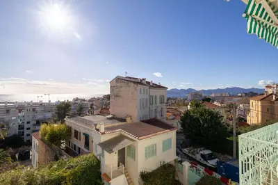 a view of a city with a building at 20 LACROIX - Cozy 2-bedroom apartment with balcony and sea view in Cannes
