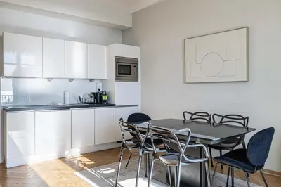 a kitchen and dining room with a table and chairs at 20 LACROIX - Cozy 2-bedroom apartment with balcony and sea view in Cannes