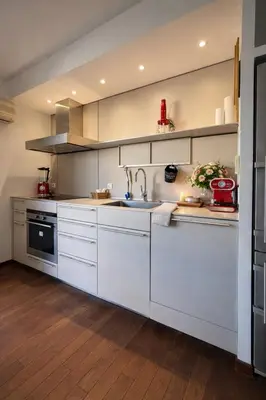 a kitchen with white cabinets and a sink at VERCORS next to the Sea & Beach in Cannes