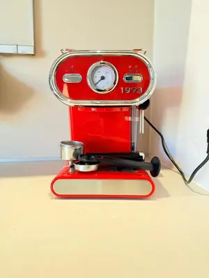 a red sewing machine sitting on a table at VERCORS next to the Sea & Beach in Cannes