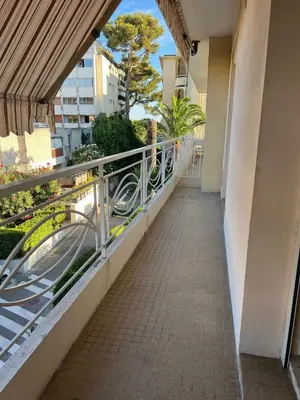 a balcony of a building with a walkway at VERCORS next to the Sea & Beach in Cannes