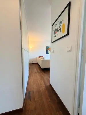 a hallway leading to a living room with a couch at VERCORS next to the Sea & Beach in Cannes