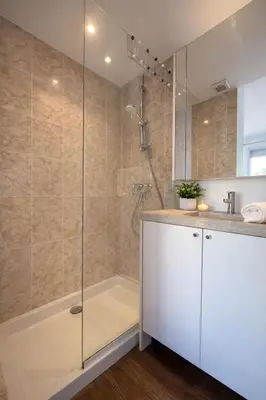 a bathroom with a shower and a tub at VERCORS next to the Sea & Beach in Cannes