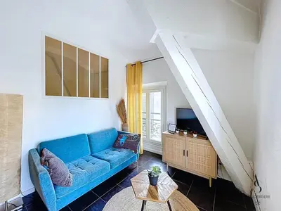 a living room with a blue couch and a tv at Le Week 5 min Palais 3 bedrooms WIFI in Cannes