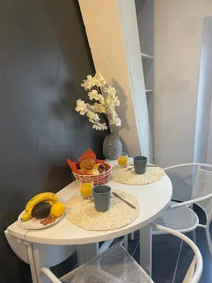 a white table with two cups and fruit on it at Le Week 5 min Palais 3 bedrooms WIFI in Cannes