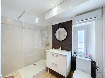 a bathroom with a shower and a sink and a mirror at Le Week 5 min Palais 3 bedrooms WIFI in Cannes