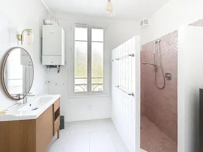 a white bathroom with a shower and a sink at Maison Noble in Cannes