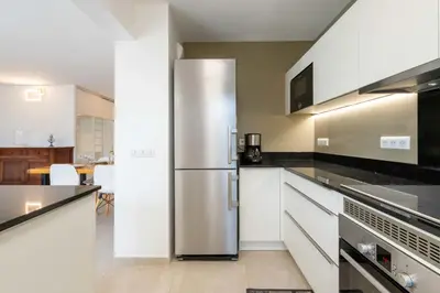 a kitchen with a stainless steel refrigerator at Ground-Floor 2 Br - Near Centre & Beaches in Cannes