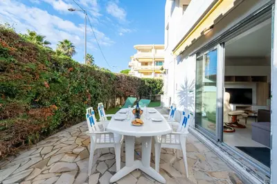 a white table and chairs on a patio at Ground-Floor 2 Br - Near Centre & Beaches in Cannes