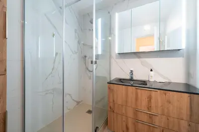 a bathroom with a shower and a sink at Ground-Floor 2 Br - Near Centre & Beaches in Cannes