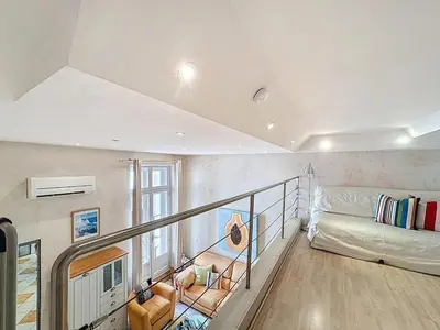 a living room with a staircase with a couch at Cosy Short-Term Rental in Cannes in Cannes