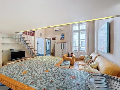 a living room with a large bed and a couch at Cosy Short-Term Rental in Cannes in Cannes