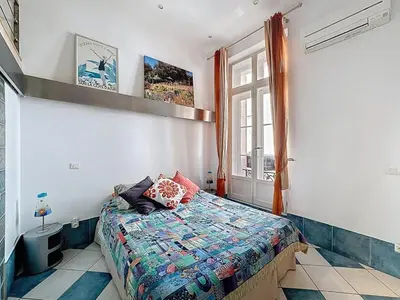 a bedroom with a bed and a window at Cosy Short-Term Rental in Cannes in Cannes